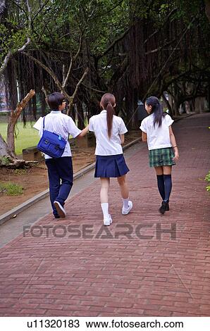 Stock Image - Teenagers walking in the campus together, rear view, Teenager. Fotosearch