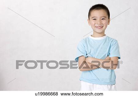 Little boy standing with arms crossed and smiling, Family, Leisure Activities View Large Photo Image Stock Photo - Little boy standing with arms crossed and smiling, Family, Leisure Activities. Fotosearch
