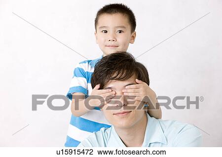 Little boy's hands covering on man's eyes, Family, Leisure Activities View Large Photo Image Stock Image - Little boy's hands covering on man's eyes, Family, Leisure Activities. Fotosearch