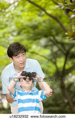 Man and little boy looking up with a telescope, Family, Leisure Activities View Large Photo Image Stock Image - Man and little boy looking up with a telescope, Family, Leisure Activities. Fotosearch