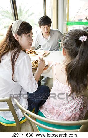 Young family with little girl dining in the restaurant, Family, Leisure Activities View Large Photo Image Stock Image - Young family with little girl dining in the restaurant, Family, Leisure Activities. Fotosearch