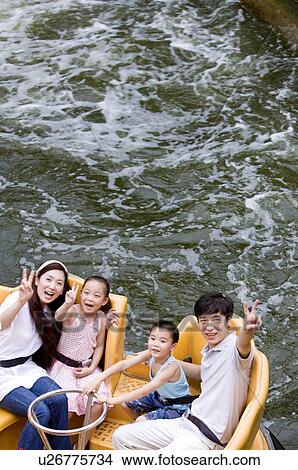 Young family with two children playing on the water and gesturing with smile, Family, Leisure Activities View Large Photo Image Picture - Young family with two children playing on the water and gesturing with smile, Family, Leisure Activities. Fotosearch