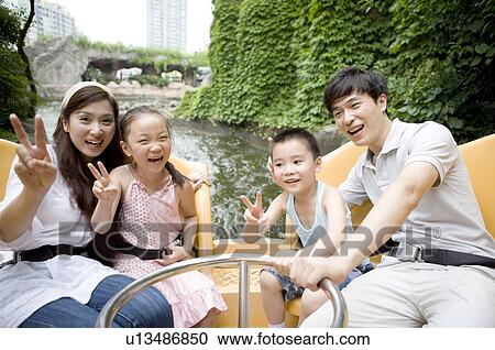 Young family with two children playing on the water and gesturing with smile, Family, Leisure Activities View Large Photo Image Stock Image - Young family with two children playing on the water and gesturing with smile, Family, Leisure Activities. Fotosearch