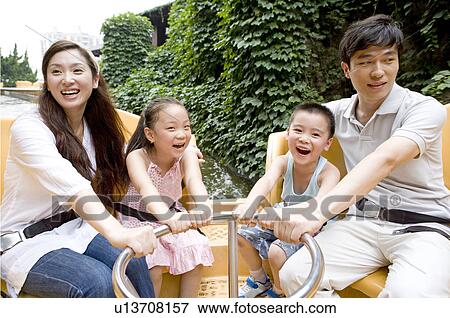Young family with two children playing on the water and smiling happily, Family, Leisure Activities View Large Photo Image Stock Photo - Young family with two children playing on the water and smiling happily, Family, Leisure Activities. Fotosearch