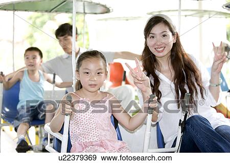 Young family with two children playing in the amusement Family and smiling happily, Leisure Activities View Large Photo Image Stock Photo - Young family with two children playing in the amusement Family and smiling happily, Leisure Activities. Fotosearch