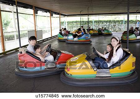 Young family with two children playing bumper cars together in the amusement park, Family, Leisure Activities View Large Photo Image Stock Photography - Young family with two children playing bumper cars together in the amusement park, Family, Leisure Activities. Fotosearch