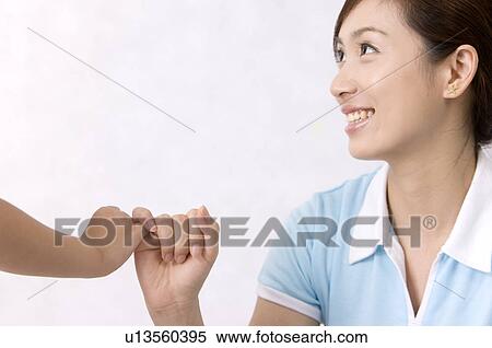 Young woman holding hands with little girl and smiling, Family, Leisure Activities View Large Photo Image Stock Photography - Young woman holding hands with little girl and smiling, Family, Leisure Activities. Fotosearch