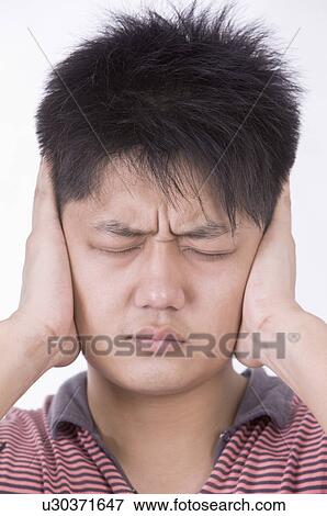 Stock Photo - Portrait of man frowning with eyes closed, Men, Facial Expression. Fotosearch