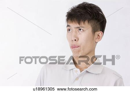 Portrait of man making a face, Men, Facial Expression View Large Photo Image Stock Photography - Portrait of man making a face, Men, Facial Expression. Fotosearch