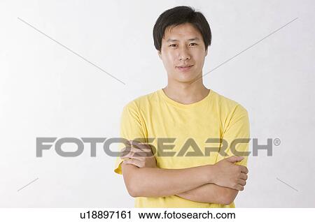 Portrait of man smiling with arms crossed, Men, Facial Expression View Large Photo Image Stock Image - Portrait of man smiling with arms crossed, Men, Facial Expression. Fotosearch