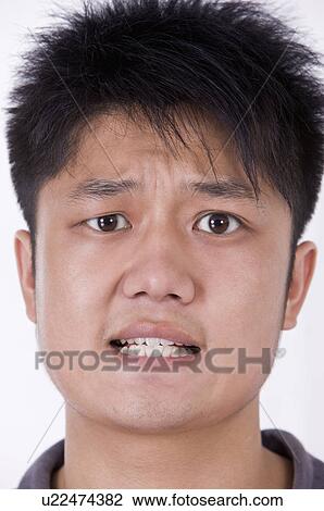 Stock Image - Portrait of man's distracted face, Men, Facial Expression. Fotosearch