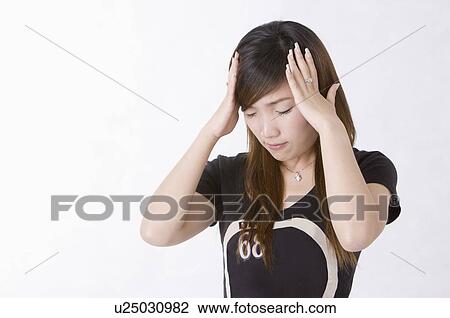 Stock Image - Portrait of woman contemplating with hand in hair, Women, Facial Expression. Fotosearch