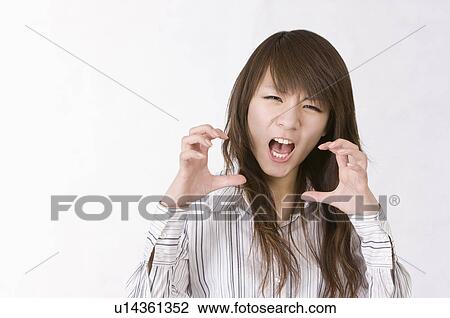 Stock Image - Portrait of woman making a face and gesturing, Women, Facial Expression. Fotosearch