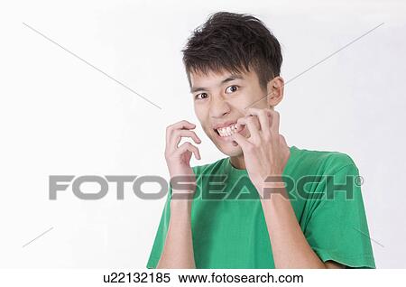 Stock Photography - Portrait of young man making a face, Men, Facial Expression. Fotosearch