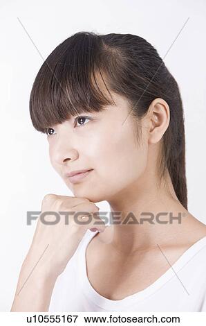 Stock Photo - Portrait of young woman contemplating and looking away, Women, Facial Expression. Fotosearch