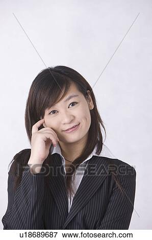 Stock Photo - Portrait of young woman smiling, Women, Facial Expression. Fotosearch