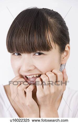 Stock Photography - Portrait of young woman smiling, Women, Facial Expression. Fotosearch