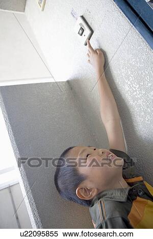 Stock Photography - Boy ringing doorbell. Fotosearch