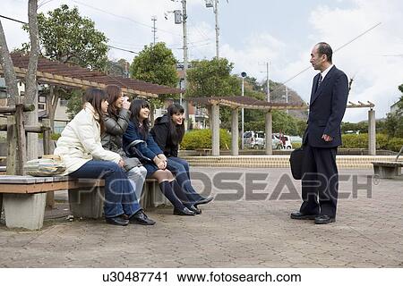 Stock Image - Five people developing neighborly ties. Fotosearch