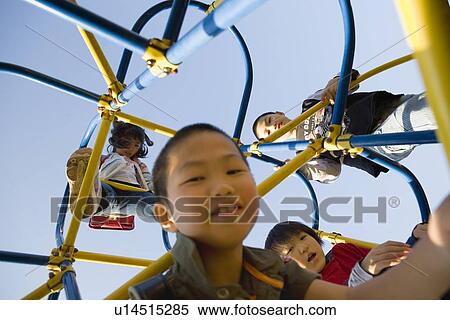 Stock Photography - Four children playing on jungle gym. Fotosearch