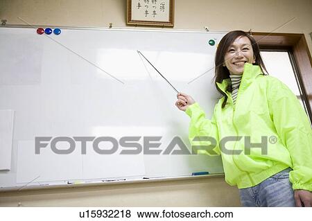 Stock Photo - Mature woman pointing board. Fotosearch