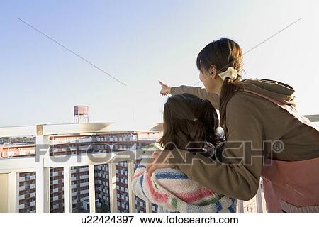 Stock Photo - Mother and daughter looking far away. Fotosearch