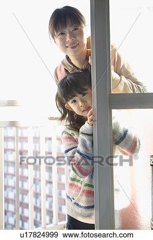 Mother and daughter standing at balcony View Large Photo Image Stock Photo - Mother and daughter standing at balcony. Fotosearch