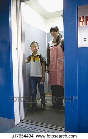Picture - Mother and son on elevator. Fotosearch