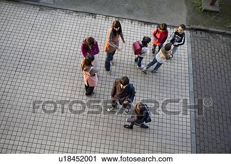 Stock Image - Residents in housing complex. Fotosearch