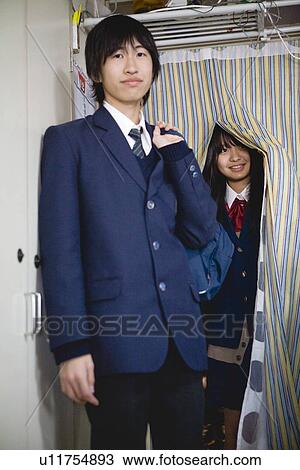 Teenage boy and girl standing View Large Photo Image Stock Image - Teenage boy and girl standing. Fotosearch