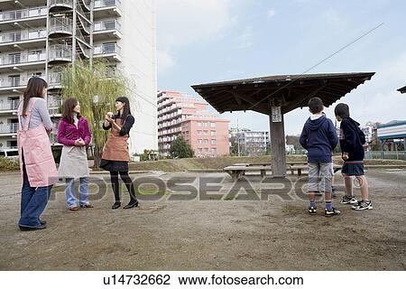 Stock Image - Three families chatting. Fotosearch