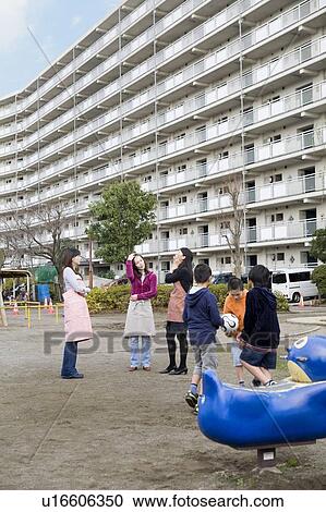 Stock Image - Three families chatting. Fotosearch