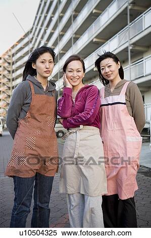 Three housewives standing in front of housing complex View Large Photo Image Stock Photography - Three housewives standing in front of housing complex. Fotosearch