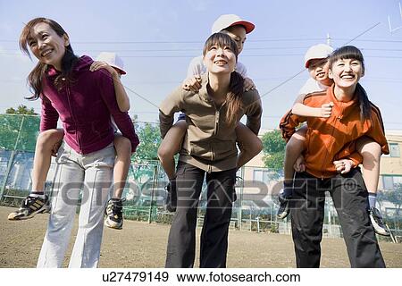 Stock Photo - Three mothers carrying children on their back. Fotosearch