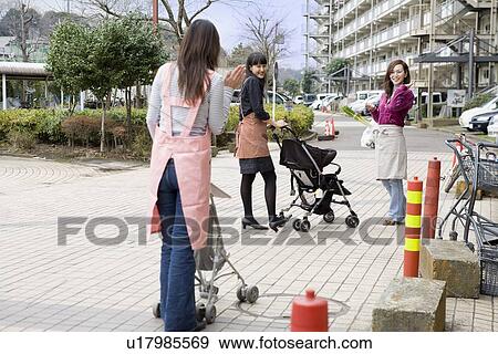 Three women greeting in front of apartment building View Large Photo Image Stock Photo - Three women greeting in front of apartment building. Fotosearch