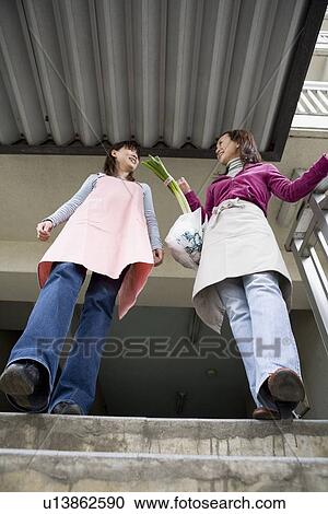 Two women chatting at steps View Large Photo Image Stock Image - Two women chatting at steps. Fotosearch