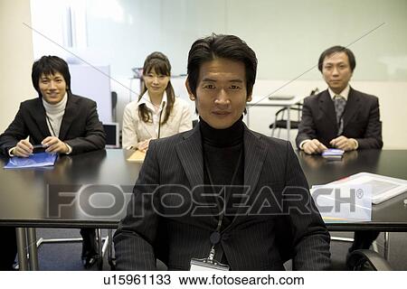 Four people meeting at table View Large Photo Image Stock Image - Four people meeting at table. Fotosearch