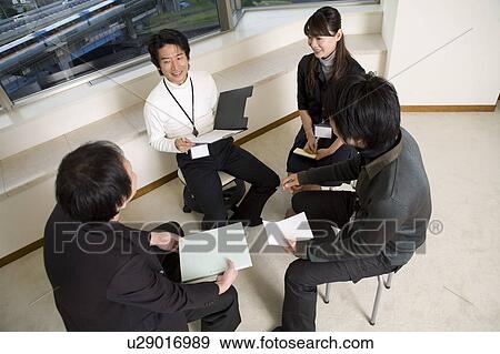 Four people meeting by window View Large Photo Image Stock Photo - Four people meeting by window. Fotosearch