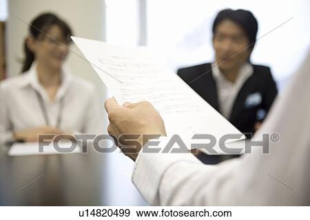 Stock Photo - Human hand holding document. Fotosearch