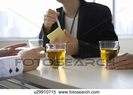 Stock Photography - Human hand on meeting table. Fotosearch