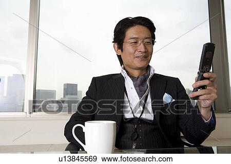 Mature man looking at cellular phone View Large Photo Image Stock Photo - Mature man looking at cellular phone. Fotosearch