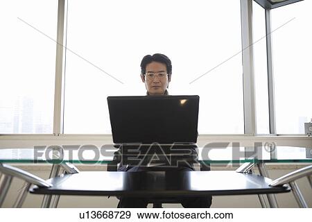 Stock Photo - Mature man looking at computer monitor. Fotosearch