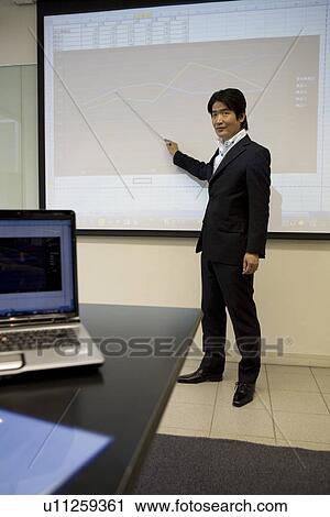 Stock Image - Mature man making a presentation. Fotosearch