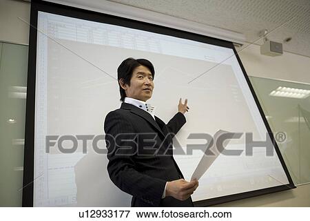 Stock Photo - Mature man making a presentation. Fotosearch
