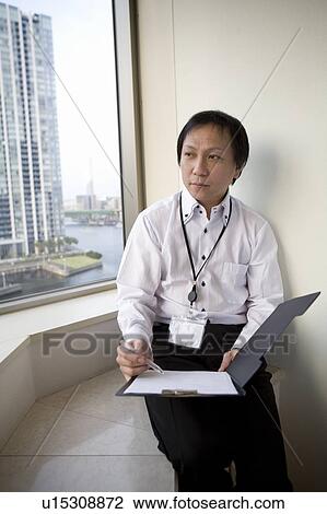 Mature man sitting by the window View Large Photo Image Stock Image - Mature man sitting by the window. Fotosearch