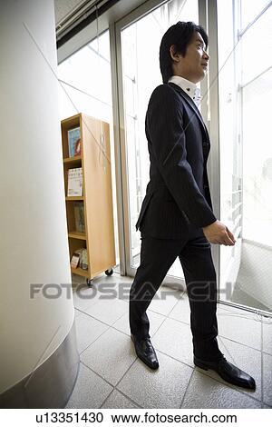 Mature man walking in office View Large Photo Image Stock Image - Mature man walking in office. Fotosearch