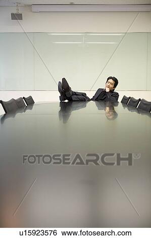 Stock Photograph - Portrait of mature man at meeting table. Fotosearch
