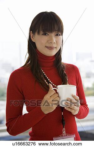 Stock Photograph - Portrait of young woman in office. Fotosearch