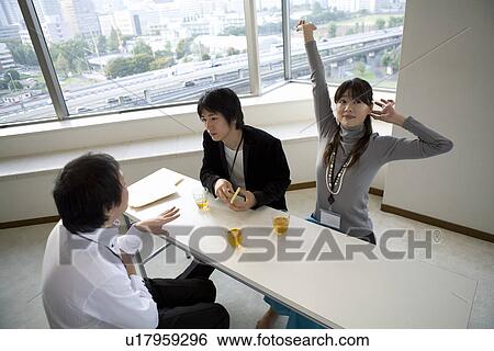 Stock Photograph - Three people having a break. Fotosearch