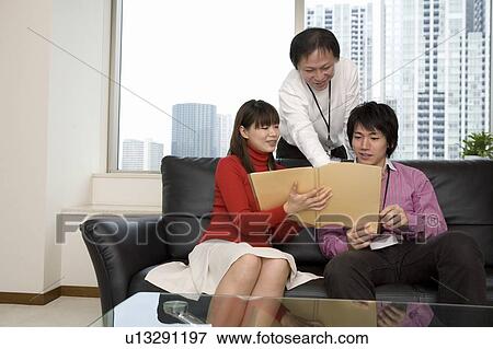 Three people meeting at sofa View Large Photo Image Stock Photo - Three people meeting at sofa. Fotosearch